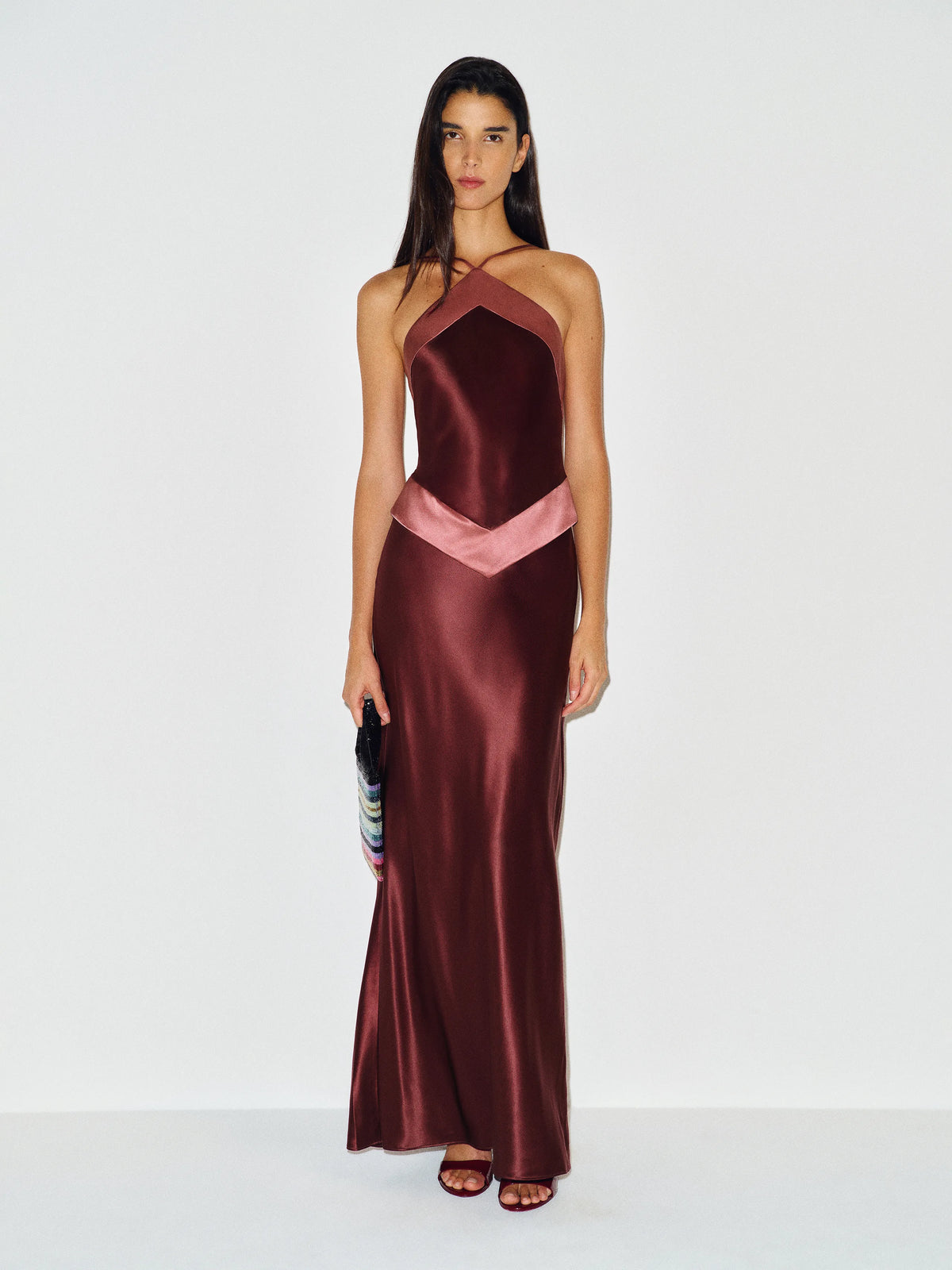 Featuring a soft pink chevron panelling along the halter neckline and waist,this dress is the ultimate statement piece for luxury resort getaways.