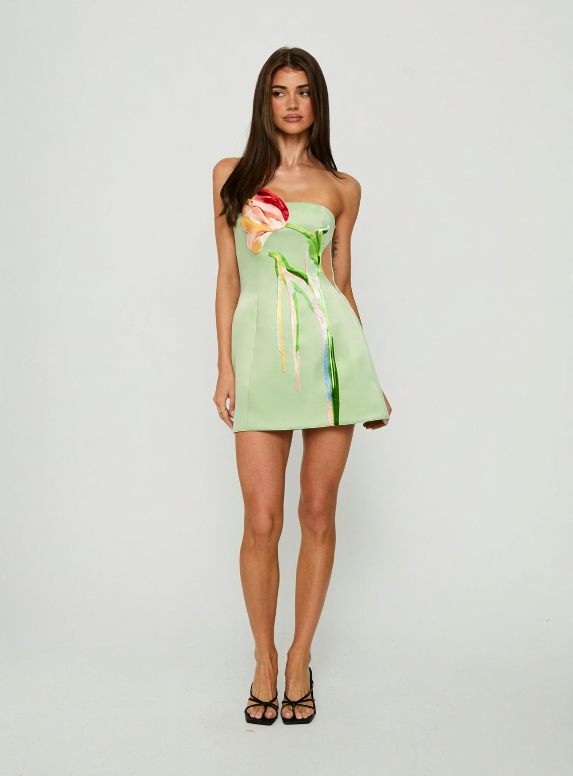Shop the Tulip Bustier Mini Dress at Seashellly. Featuring a pastel green hue, playful floral details, and a feminine mini silhouette.