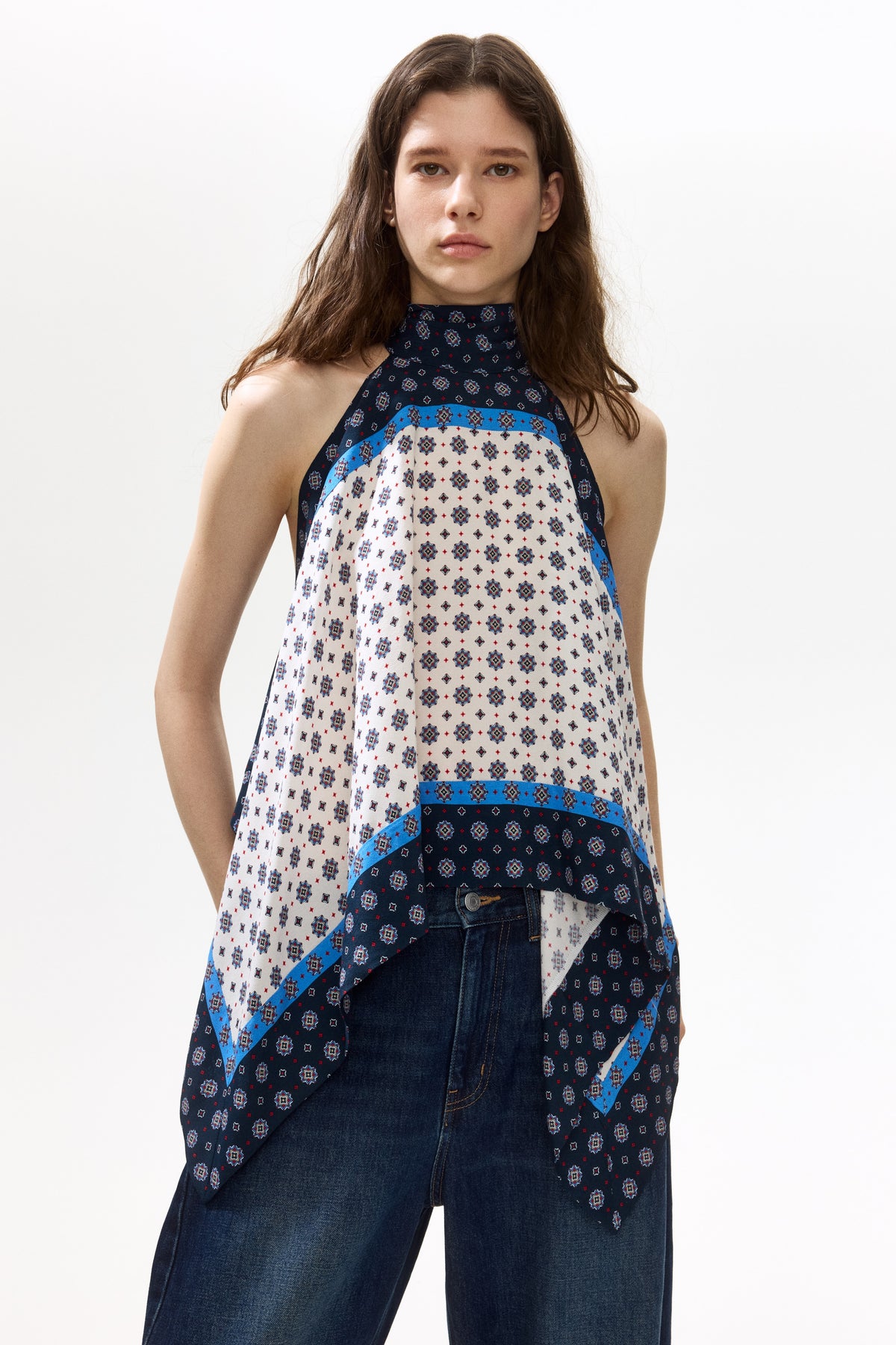 Featuring a sophisticated bandana-style, and geometric mosaic patterns, this top is the ultimate statement piece for luxury resort getaways.