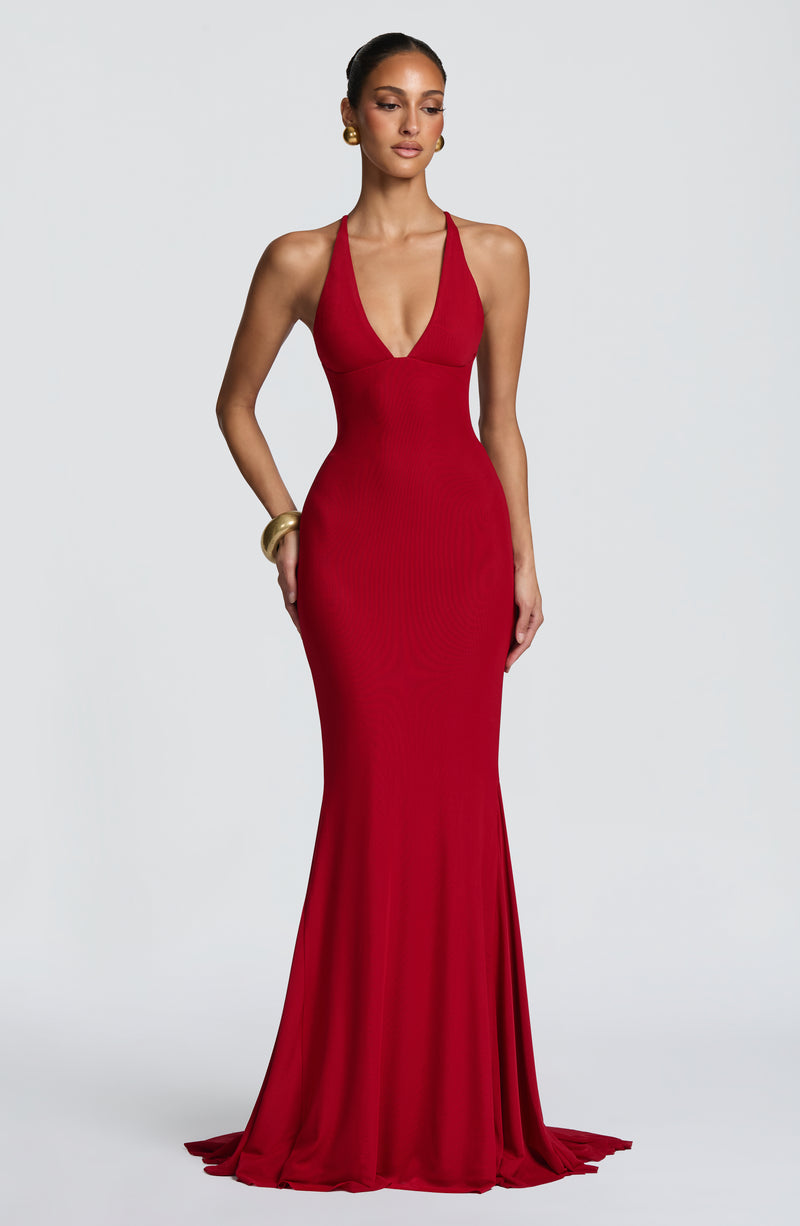 Featuring a daring plunging V-neckline, and a dramatic flared mermaid hemline, this dress is the ultimate statement piece for luxury resort getaways.