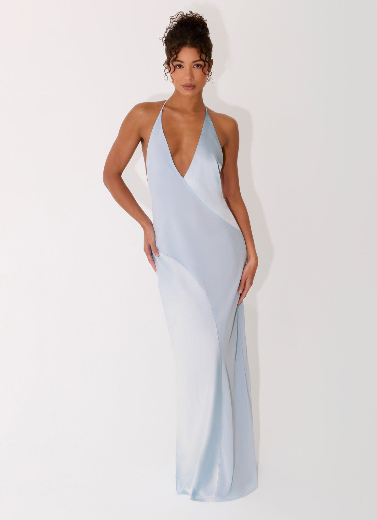 Featuring a daring plunging V-neckline,this dress is the ultimate statement piece for luxury resort getaways and high-end evening events.