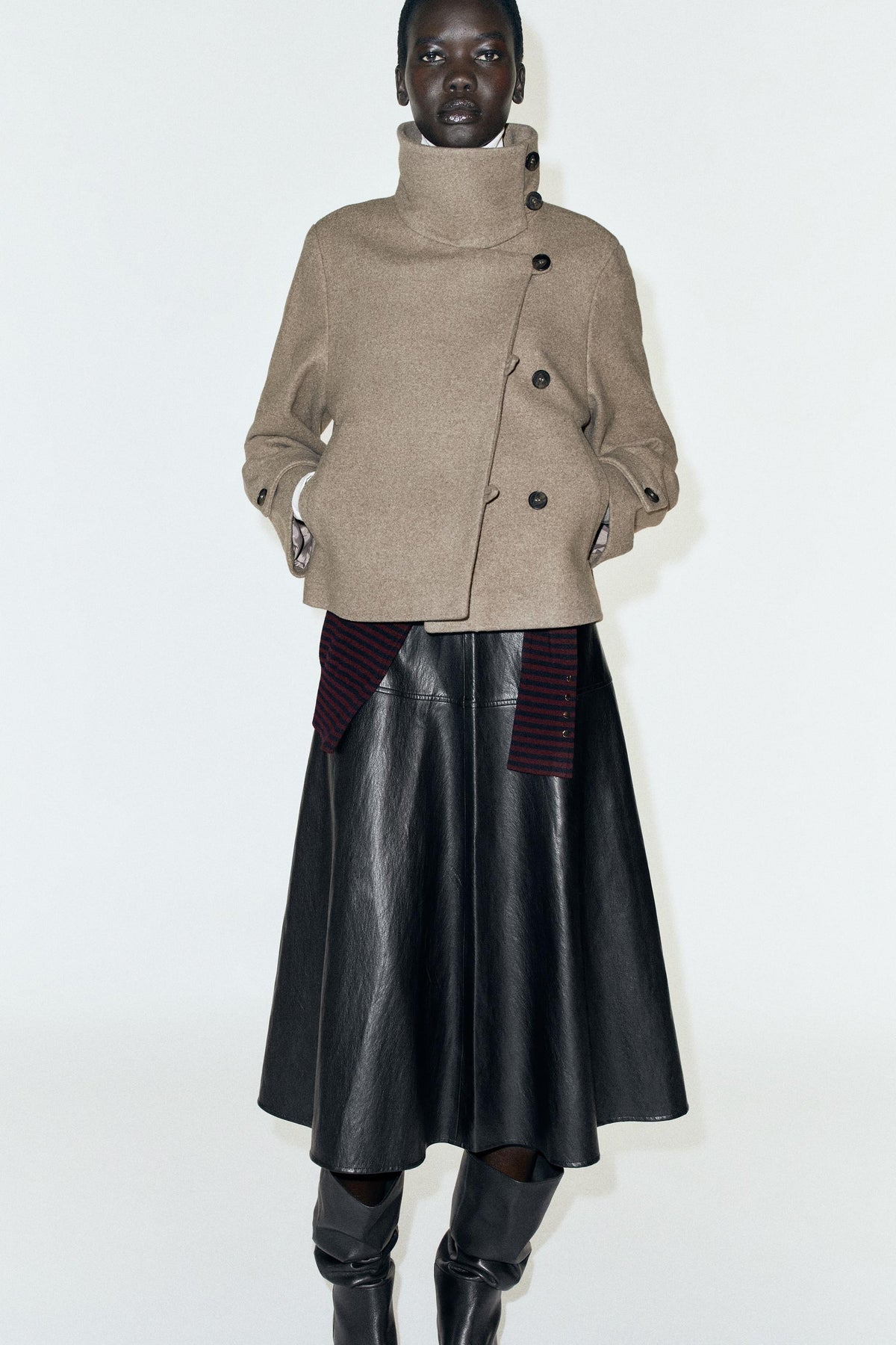 Featuring a striking asymmetric high collar, welt pockets, and a chic cropped silhouette, this jacket is the ultimate statement piece for luxury resort getaways.
