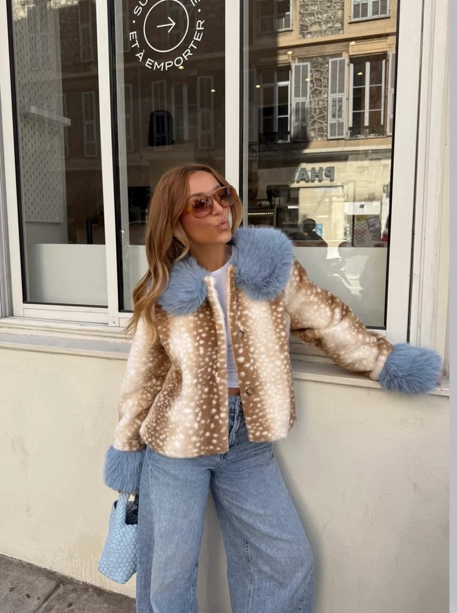 Featuring a animal print body contrasted with vibrant powder blue plush faux-fur, this cropped jacket is the ultimate statement piece for luxury resort getaways.