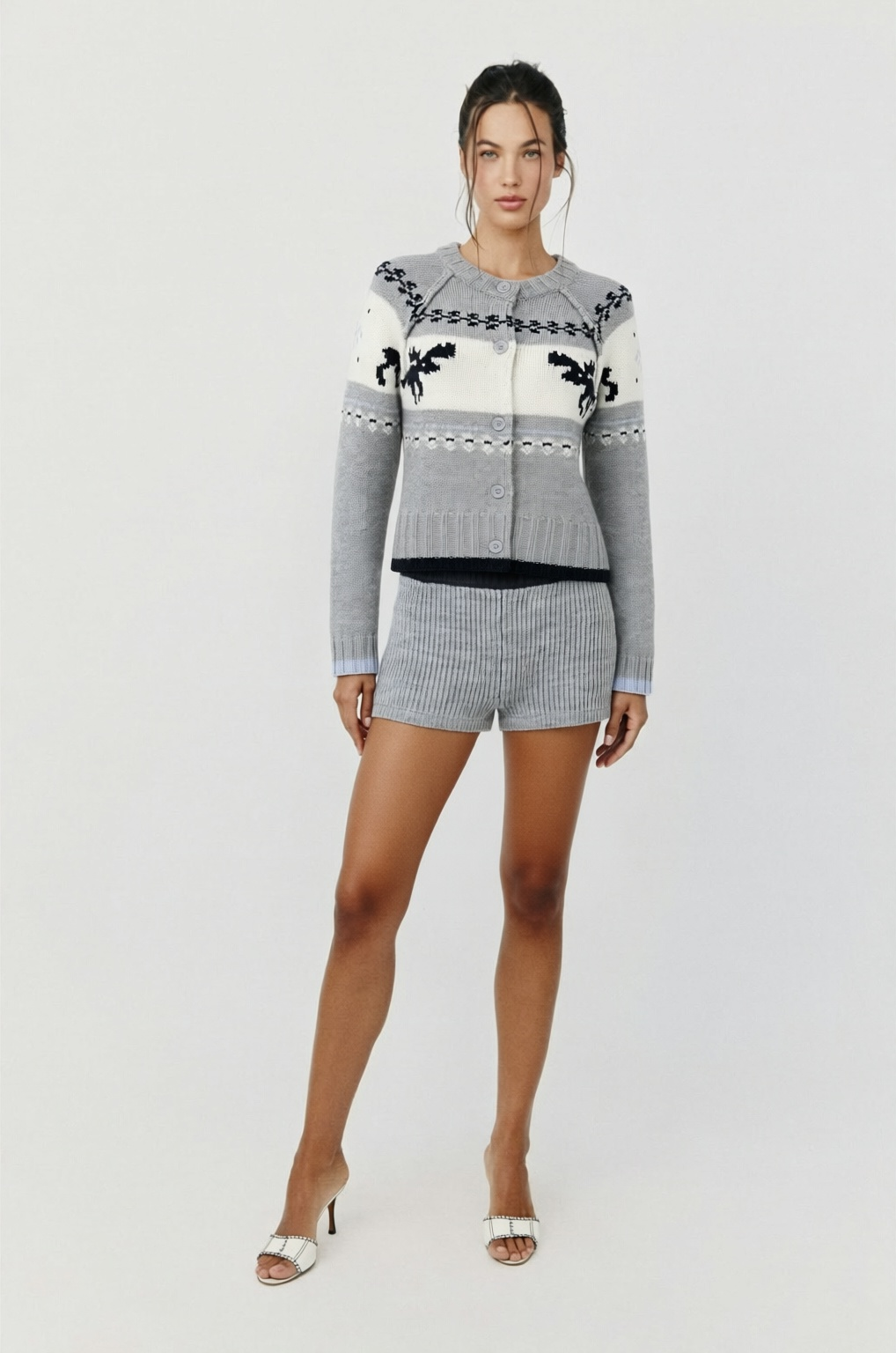 Featuring a button-front cardigan, and matching high-waisted knit shorts, this two-piece set is the ultimate statement piece for luxury winter resort getaways.