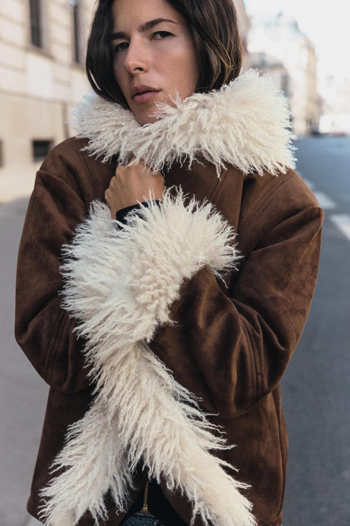 Elevate your wardrobe with the Seashellly Shearling Trimmed Suede Jacket. Features rich brown suede, plush shaggy shearling lapels, and cozy cuffs.
