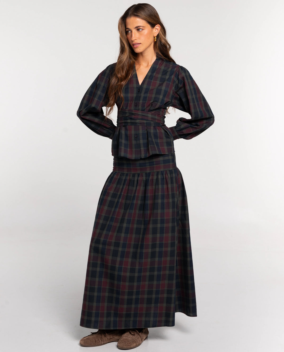 Elevate your autumn wardrobe with the Seashellly Plaid Wrap-Waist Two-Piece Maxi Set. Featuring V-neck balloon sleeve blouse and tiered plaid maxi skirt.